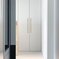 an empty hallway with white walls and doors