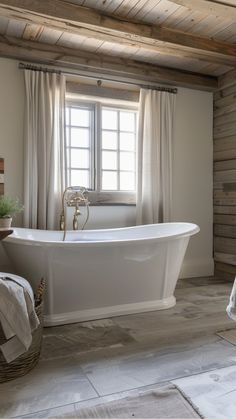 a white bath tub sitting next to a window