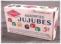 an unopened jujubes box sitting on top of the floor in front of a wall