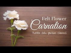 two white flowers sitting on top of a wooden table with the words, felt flower carnation