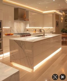 a modern kitchen with marble counter tops and white cabinets is lit by recessed lighting