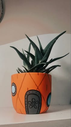 a potted plant sitting on top of a white shelf