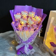 a bouquet of flowers with hello kitty lights in the middle and a card box behind it