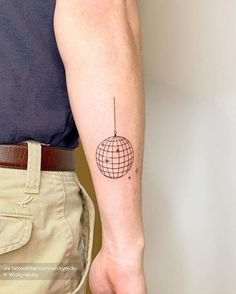 a man's arm with a tattoo on it that has a globe on it