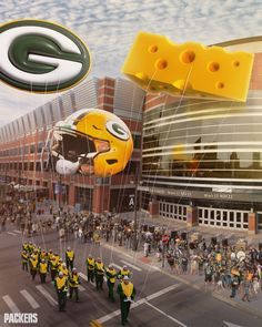 the green bay packers are paraded down the street with balloons in the shape of football helmets