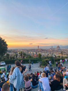 many people are sitting on the ground and watching something