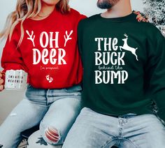 two people wearing ugly sweaters with the words oh deer and the buck on them