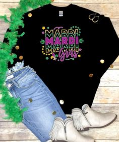 a black shirt with mardi gras lettering on it and some green feathers around it