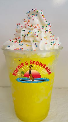 a yellow cup filled with whipped cream and sprinkles