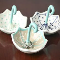 two ceramic umbrella shaped dishes on a table