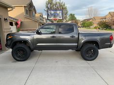 a gray truck parked in front of a house