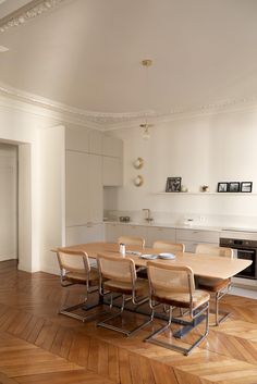 a dining room table and chairs in front of an oven