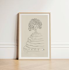 a drawing of a tree on top of a stack of books in front of a wall