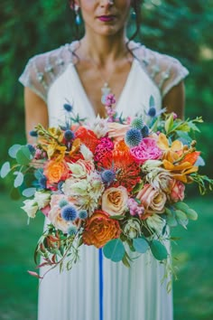 a woman holding a bouquet of flowers in her hands