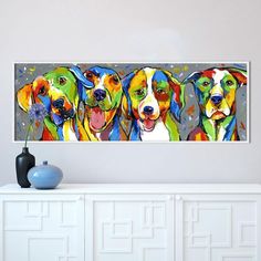 three colorful dogs on a gray background are featured in this modern art piece, which is mounted above a white cabinet