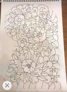 a drawing with flowers on it sitting on top of a table