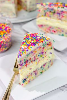 a slice of cake with sprinkles on it and a fork in the foreground