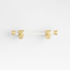 two white and gold door handles with round knobs on each side, against a white background