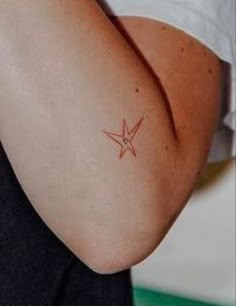 a woman with a small star tattoo on her arm