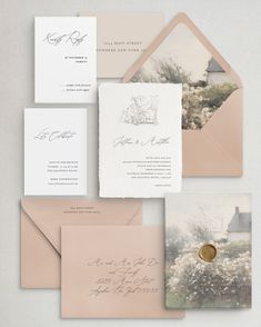 the wedding stationery is laid out on top of each other, with an envelope and two