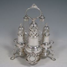 an ornate silver and glass candle holder with five candles in the shape of a heart