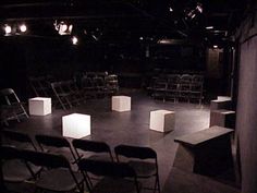 an empty stage with chairs and lights