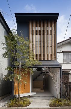 an apartment building with wooden slats on the roof and side walls, in japan