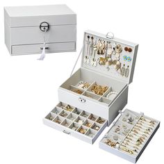 an open jewelry box with many different types of earrings and necklaces in it on a white background