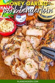 grilled pork chops on a cutting board with honey and garlic