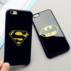 the batman and superman symbol phone cases are next to each other