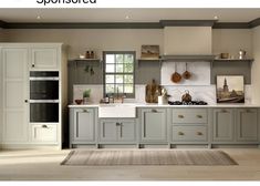 a large kitchen with gray cabinets and white counter tops, along with an area rug on the floor