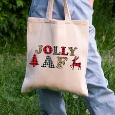 a person carrying a tote bag that says jolly aff