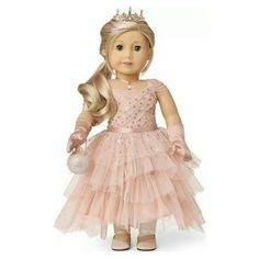 a doll with blonde hair wearing a pink dress and holding a white ball in her hand