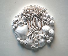 there are many different types of sea shells on this wall hanging ornament set