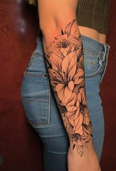 a woman's arm with flowers on it and the bottom half of her arm