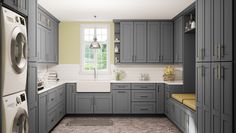 a laundry room with gray cabinets and washer and dryer in the corner, next to a window