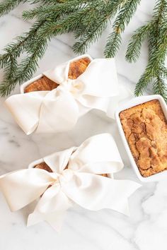 two small white dishes filled with baked goods