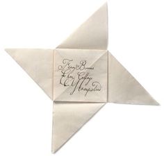 an origami star with writing on it