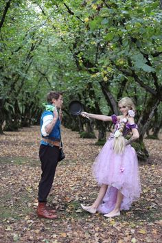 a man and woman dressed up in costumes playing frisbee golf with each other