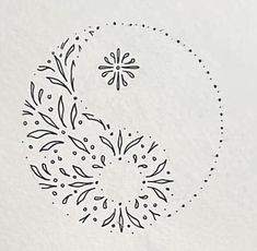 a drawing of a flower in the middle of a circle with dots and leaves on it