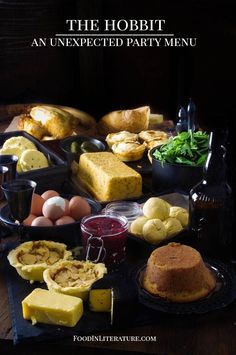 a table topped with lots of different types of food next to bread and other foods