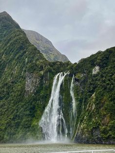 a large waterfall in the middle of a body of water