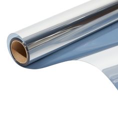 a roll of shiny silver foil on a white background