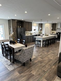 a large open floor plan with kitchen and living room in the backgrounnd