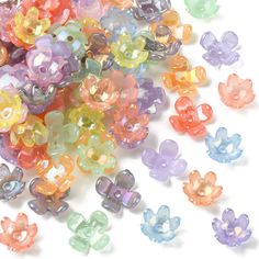 many different colored beads on a white surface