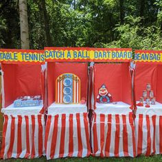 three red and white striped tents sitting next to each other