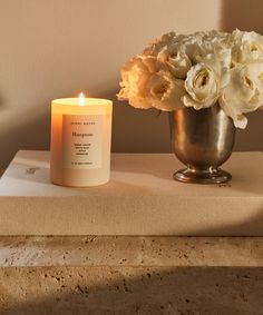 a candle and some flowers on a table