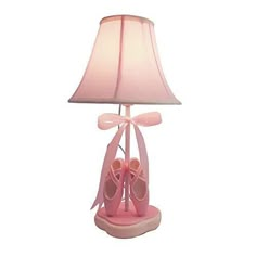 a lamp that is on top of a table with pink shoes in front of it