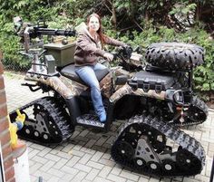 a woman sitting on top of an atv