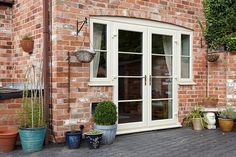 a brick building with potted plants outside